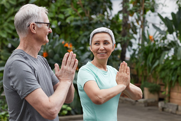 Picture of two retired seniors doing yoga